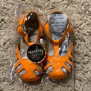 NIB orange monkey feet